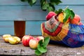 Summer rustic still life, a basket of ripe garden apples on a wooden background, apple juice in a transparent glass. Seasonal Royalty Free Stock Photo