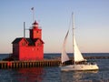Michigan red lighthouse with sailboat