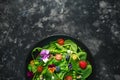 Summer salad with edible flowers, spinach, blueberries, raspberry, sweet peas, cherry tomatos and feta cheese Royalty Free Stock Photo