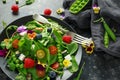 Summer salad with edible flowers, spinach, blueberries, raspberry, sweet peas, cherry tomatos and feta cheese Royalty Free Stock Photo