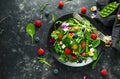 Summer salad with edible flowers, spinach, blueberries, raspberry, sweet peas, cherry tomatos and feta cheese Royalty Free Stock Photo