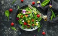 Summer salad with edible flowers, spinach, blueberries, raspberry, sweet peas, cherry tomatos and feta cheese Royalty Free Stock Photo
