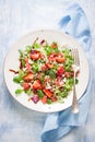 Summer salad with grapefruit, strawberry, mint, balsamic and cheese on a plate on a wooden background Royalty Free Stock Photo