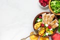 Summer salad with grilled chicken and peach, feta cheese and raspberries in a bowl with fork. healthy food. top view Royalty Free Stock Photo