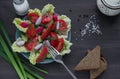 Summer salad of ripe vegetables and greens with black bread and spices on the table