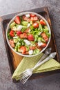 Summer salad of strawberries, avocado, bacon, lettuce, goat cheese close-up in a bowl. Vertical top view Royalty Free Stock Photo