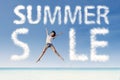 Summer sale clouds and woman jumping at beach Royalty Free Stock Photo