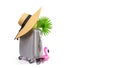 Summer sale. Travel accessories with suitcase, straw hat, palm leaves and pink flamingo in minimal trip vacation concept isolated Royalty Free Stock Photo