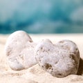 Summer sand sea beach with waves and heart stones Royalty Free Stock Photo