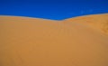 Summer sandy desert dune on a blue sky backgrou