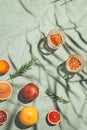 Summer scene with fruits,rosemary, glass of water and books on pastel  beach towel. Drinks and refreshment concept. Sunlit Royalty Free Stock Photo