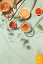 Summer scene with fruits,rosemary, glass of water and books on pastel green beach towel. Drinks and refreshment concept. Sunlit Royalty Free Stock Photo