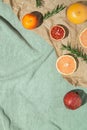 Summer scene with fruits,rosemary, glass of water and books on pastel green beach towel. Drinks and refreshment concept. Sunlit Royalty Free Stock Photo