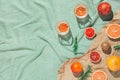 Summer scene with fruits,rosemary, glass of water and books on pastel green beach towel. Drinks and refreshment concept. Sunlit Royalty Free Stock Photo