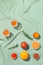 Summer scene with fruits,rosemary and glasses of water or lemonade on pastel green beach towel. Drinks and refreshment concept. Royalty Free Stock Photo