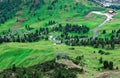 Summer scene of Gardena Pass, with highways & hiking trails winding thru the green valley Royalty Free Stock Photo