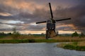 Ancient Dutch windmill in a countryside of Kinderdijk at sunset, Netherlands, Holland, rural landscape, lifestyle Royalty Free Stock Photo
