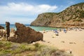 Summer scene with unidentified people in the golden beach and bl