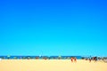 Scenery in Porto Potenza Picena with sand, people, parasols, beach equipment and sea