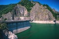 Summer scenery of Vidraru Dam and lake glowing in sunlight. Vidraru Dam, Romania. Carpathian Mountains, Fagaras ridge. Royalty Free Stock Photo