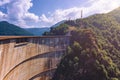 Summer scenery of Vidraru Dam and lake glowing in sunlight. Vidraru Dam, Romania. Carpathian Mountains, Fagaras ridge. Royalty Free Stock Photo