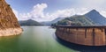 Summer scenery of Vidraru Dam and lake glowing in sunlight. Vidraru Dam, Romania. Carpathian Mountains, Fagaras ridge. Royalty Free Stock Photo