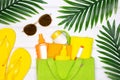 Summer sea beach vacation concept. Towels, sunscreen cosmetic products in eco bag, flip flops, sunglasses. Top view, flat lay Royalty Free Stock Photo