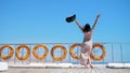 summer, sea, beautiful young brunette woman, in a long dress and sunglasses, stands on the deck of a ferry, ship Royalty Free Stock Photo