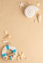 Summer sea concept. Ammonite, starfishes,snail shell and lifebuoy on sand. Top view. Copy space Royalty Free Stock Photo