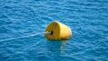 summer, sea, in transparent bluish water floats orange buoy Royalty Free Stock Photo