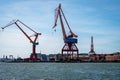 Summer seascape view of two large harbor cargo cranes against blue sky in Gothenburg Sweden. Royalty Free Stock Photo