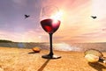 Summer seaside glass of red wine on beach stone and seashells nature panorama blue sky and sea water sunlight reflection romantic Royalty Free Stock Photo