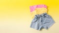 Summer set of clothes for girls and women. Denim shorts with colored T-shirts. Look for a summer vacation.