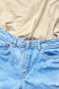 Summer set of denim trousers and beige shirts close-up. online shopping concept. vertical frame Royalty Free Stock Photo