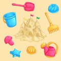 Summer set of sand toys and a large sand castle with towers and flags. Royalty Free Stock Photo