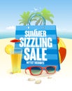 Summer sizzling sale with blue shopping bag on a beach backdrop