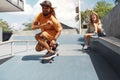 Summer. Skater Friends Skateboarding At Skatepark. Guy And Girl In Casual Outfit Having Fun Outdoor