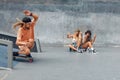 Summer. Skater Friends Skateboarding At Skatepark. Guy And Girls In Casual Outfit Having Fun Outdoor