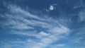 Summer sky. Cirrus clouds on bright blue sky. Wispy cirrus clouds pass over blue sky in nature.