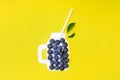 Summer smoothies with blueberry currant detox on yellow background. Berries border design. Close up top view or flat lay with