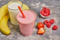 Summer smoothies strawberry, raspberry ,banana, glass milk on gray background