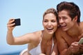 Summer snapshots. a happy young couple taking a selfie together at the beach. Royalty Free Stock Photo