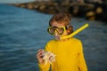 Summer snorkeling with kids. Beach vacation. Fun kid wearing a snorkel scuba mask found coral or shell in ocean water Royalty Free Stock Photo