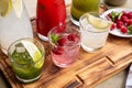 Summer soft drinks, a set of lemonades. Lemonades in jugs on the table, the ingredients of which they are made are