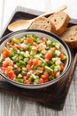 Summer Spanish Salad Pipirrana with green pepper, tomatoes, cucumber, onion and caraway closeup on the plate. Vertical