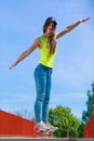 Teen girl skater riding skateboard on street. Royalty Free Stock Photo