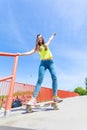 Teen girl skater riding skateboard on street. Royalty Free Stock Photo