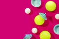 Tennis balls, table tennis balls and holiday decoration on magenta background