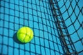 Summer sport concept with tennis ball and net on hard tennis court. Royalty Free Stock Photo