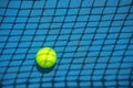 Summer sport concept with tennis ball and net on hard tennis court Royalty Free Stock Photo